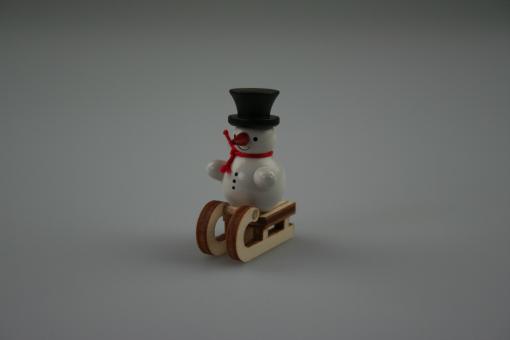 Miniatur Schneemann auf Schlitten 